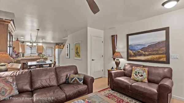 a living room with furniture and a painting