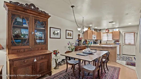 a kitchen with a table and chairs in it