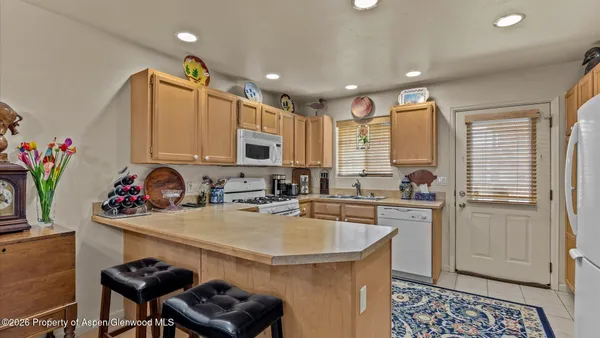 a kitchen with sink a refrigerator and cabinets