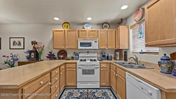 a kitchen with a white cabinets stove and sink
