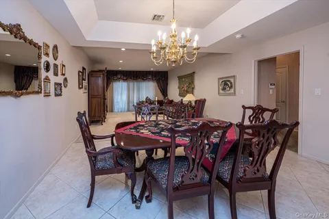 a view of a dining room with furniture and a chandelier