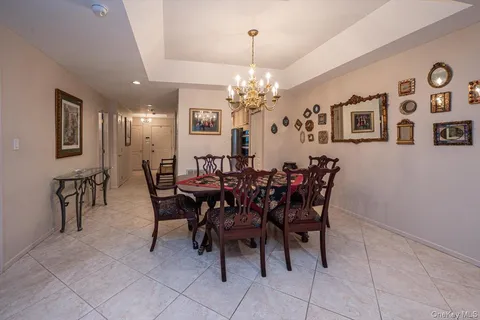 a view of a dining room with furniture and chandelier