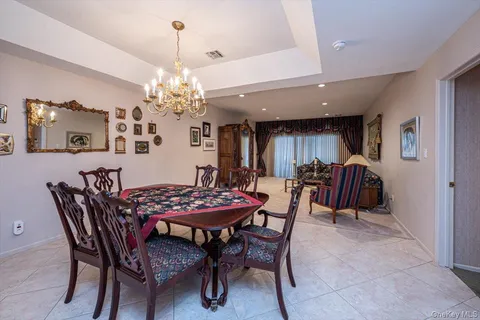 a view of a dining room with furniture and chandelier