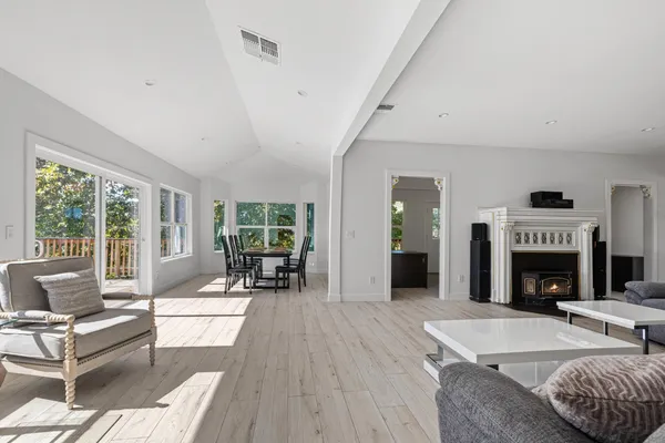 a living room with furniture large window and a fireplace