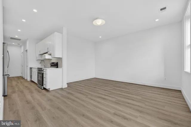 a view of kitchen with wooden floor