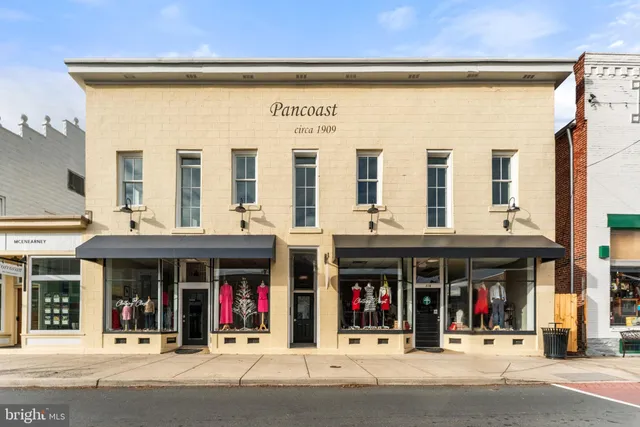 a view of a building with a large window and a man seat