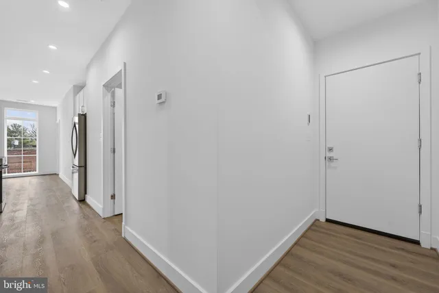 a view of hallway with wooden floor
