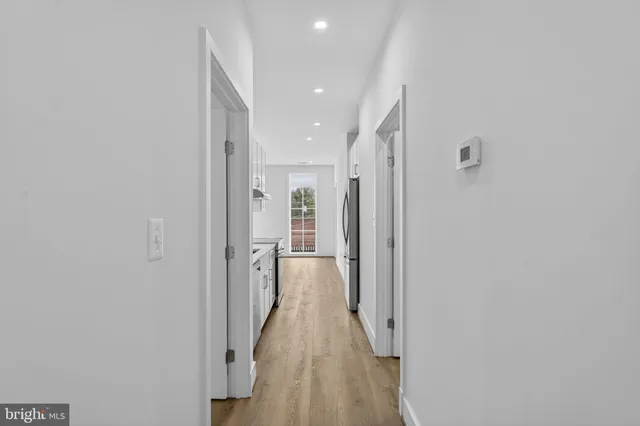 a view of hallway with wooden floor