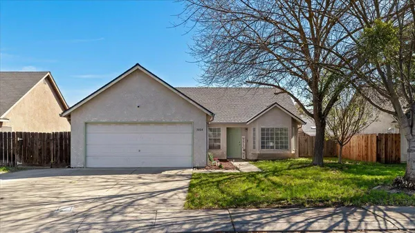 a front view of house with a garden