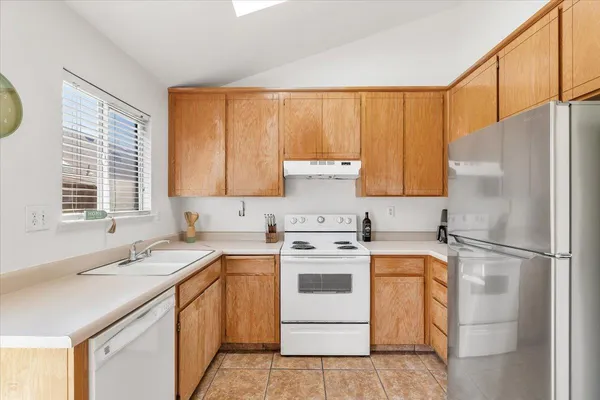 a kitchen with a stove a sink and a refrigerator