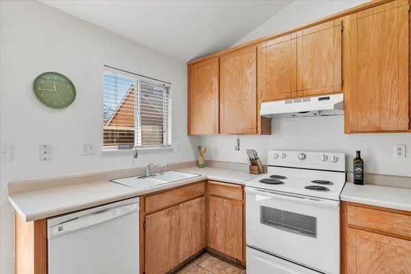 a kitchen with a sink cabinets and window