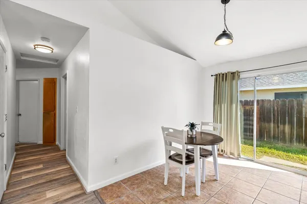 a dining room with wooden floor and a table