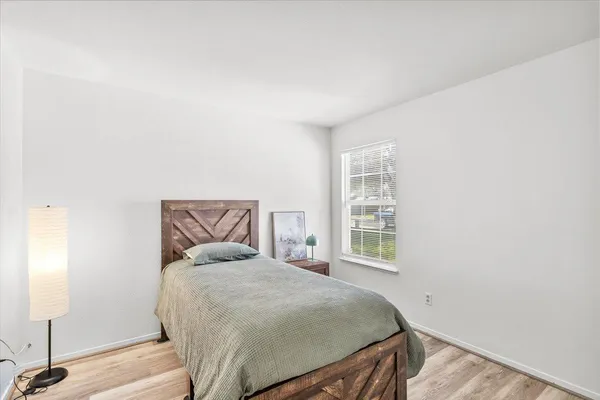 a bedroom with a bed and a window