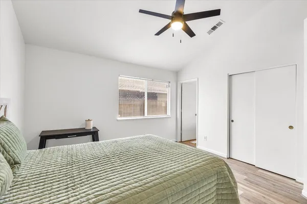 a bedroom with a bed and a window