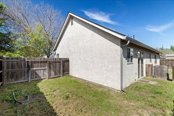 a backyard of a house with table and chairs