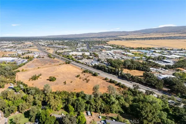 an aerial view of ocean and residential houses with outdoor space