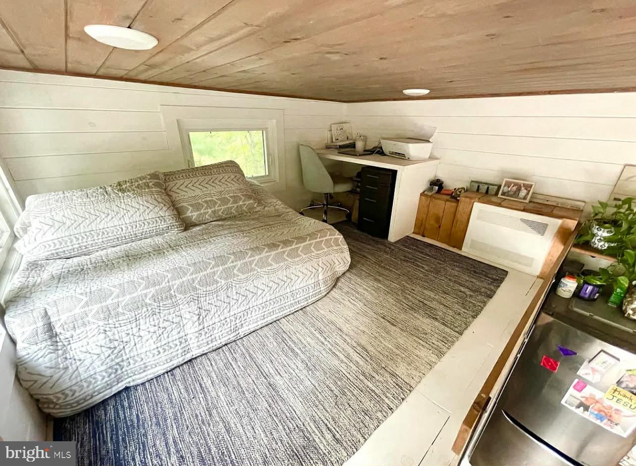 561 Corsons Tavern Road, Unit 43 Ocean View, NJ 08230 - Photo 17 of 18 a bed sitting in a bedroom next to a larger window
