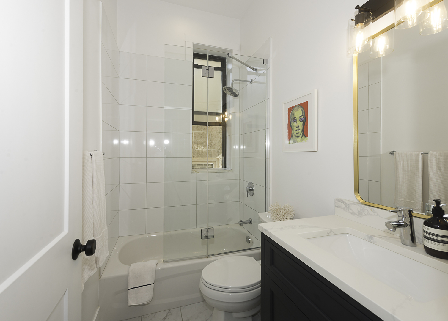 3517 North Reta Avenue, Unit 3R Chicago, IL 60657 - Photo 6 of 9 a bathroom with a sink a toilet and shower
