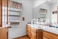 Undisclosed Address Tehachapi, CA 93561 - Photo 12 of 39 a bathroom with a granite countertop sink a mirror and cabinets