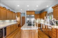 Undisclosed Address Tehachapi, CA 93561 - Photo 15 of 39 a kitchen with stainless steel appliances kitchen island granite countertop a refrigerator and a stove top oven