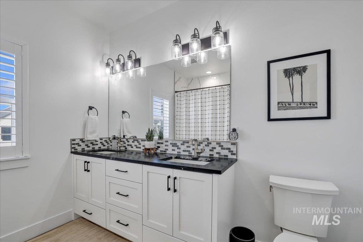 2078 Red Rock Way Twin Falls, ID 83301 - Photo 18 of 49 Full bathroom with backsplash, double vanity, and curtained shower