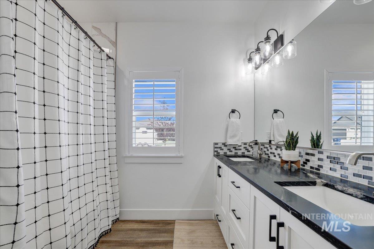 2078 Red Rock Way Twin Falls, ID 83301 - Photo 19 of 49 Bathroom featuring tasteful backsplash, double vanity, and wood finished floors