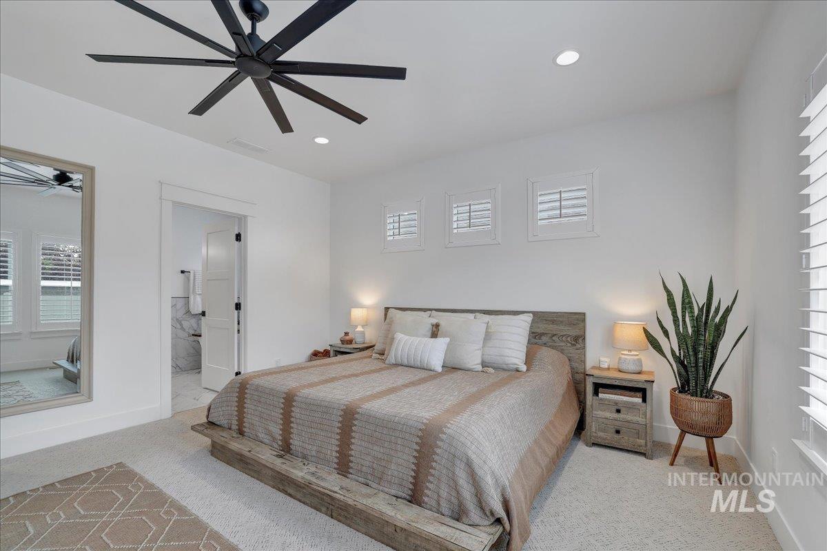 2078 Red Rock Way Twin Falls, ID 83301 - Photo 26 of 49 Carpeted bedroom featuring multiple windows, recessed lighting, a ceiling fan, and connected bathroom