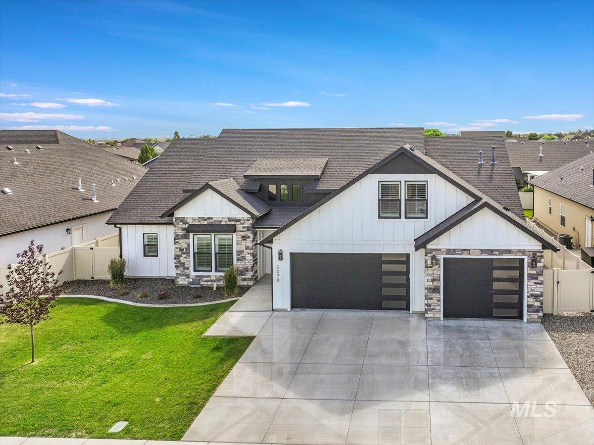 2078 Red Rock Way Twin Falls, ID 83301 - Photo 4 of 49 View of front of property featuring board and batten siding, roof with shingles, and concrete driveway