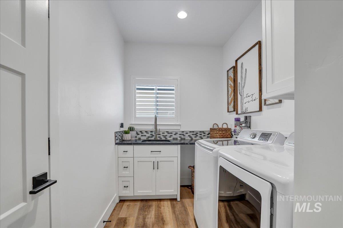 2078 Red Rock Way Twin Falls, ID 83301 - Photo 40 of 49 Laundry area with cabinet space, washing machine and clothes dryer, light wood-style floors, and recessed lighting