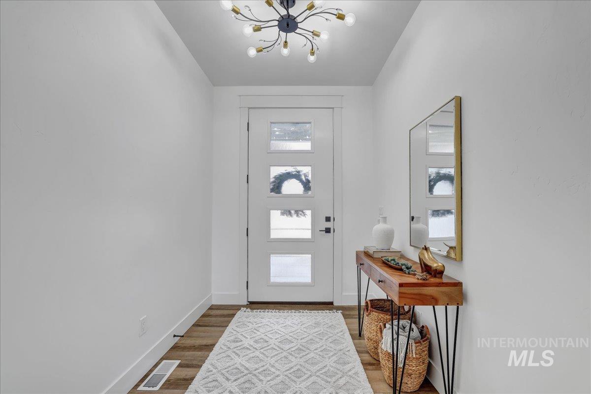 2078 Red Rock Way Twin Falls, ID 83301 - Photo 6 of 49 Foyer entrance with a chandelier and wood finished floors