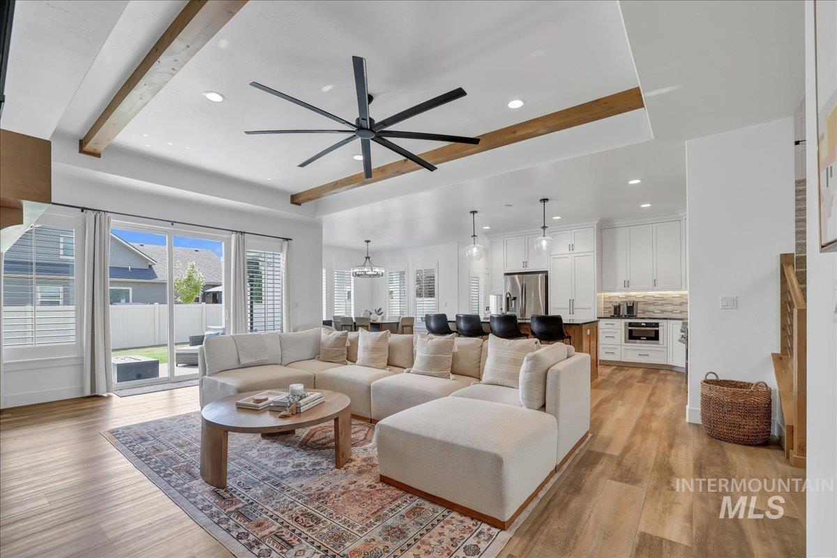2078 Red Rock Way Twin Falls, ID 83301 - Photo 8 of 49 Living room featuring beam ceiling, light wood-style floors, a ceiling fan, recessed lighting, and a chandelier