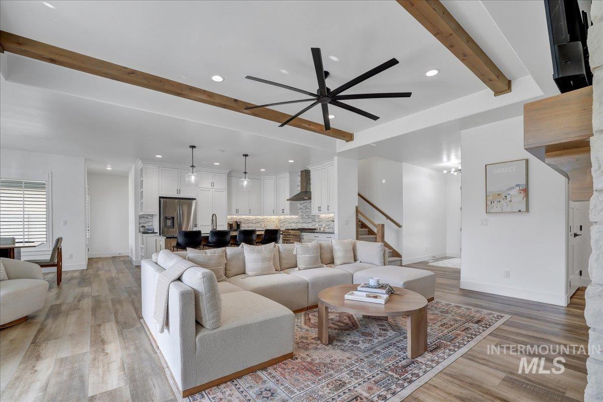 2078 Red Rock Way Twin Falls, ID 83301 - Photo 9 of 49 Living room featuring beamed ceiling, light wood-type flooring, ceiling fan, recessed lighting, and stairway