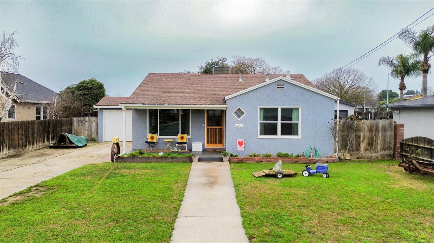 a front view of a house with a yard and porch
