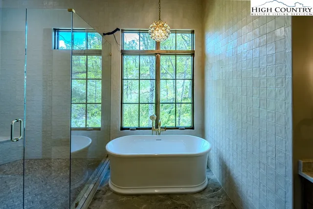 a room with a window and a chandelier