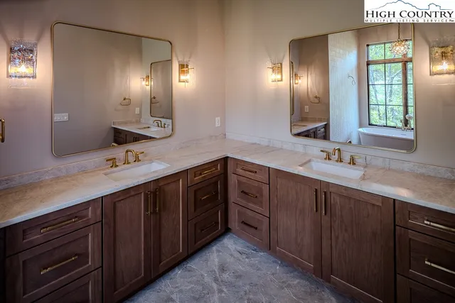 a spacious bathroom with double vanity and a mirror