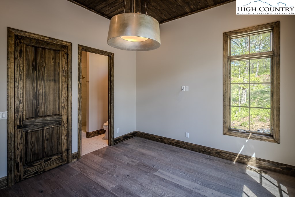 2005 Moon Run Linville, NC 28646 - Photo 19 of 37 an empty room with wooden floor cabinet and windows