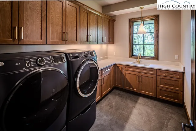 a utility room with sink dryer and washer