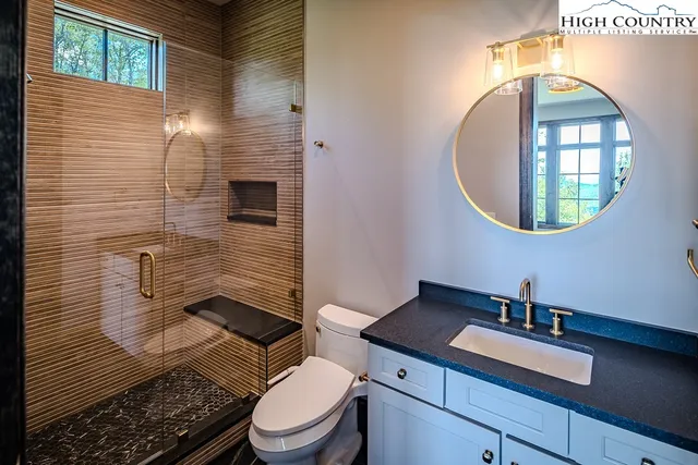 a bathroom with a toilet a sink and mirror
