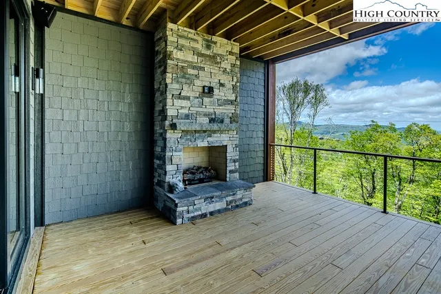 a view of livingroom with wooden floor and a fireplace