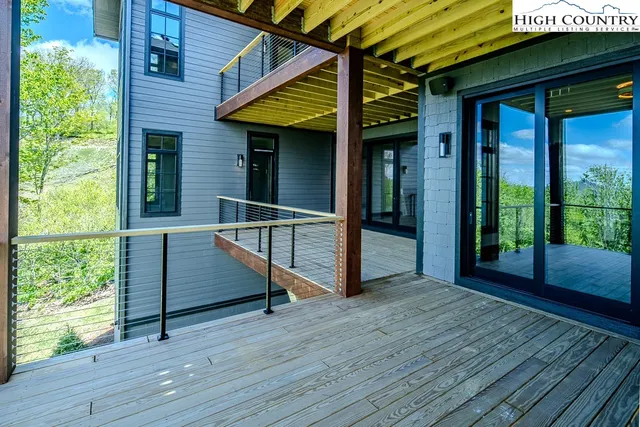 a view of porch with wooden floor and floor to ceiling window