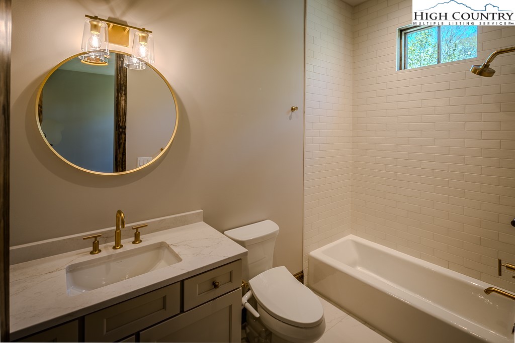 2005 Moon Run Linville, NC 28646 - Photo 32 of 37 a bathroom with a sink a toilet and a mirror
