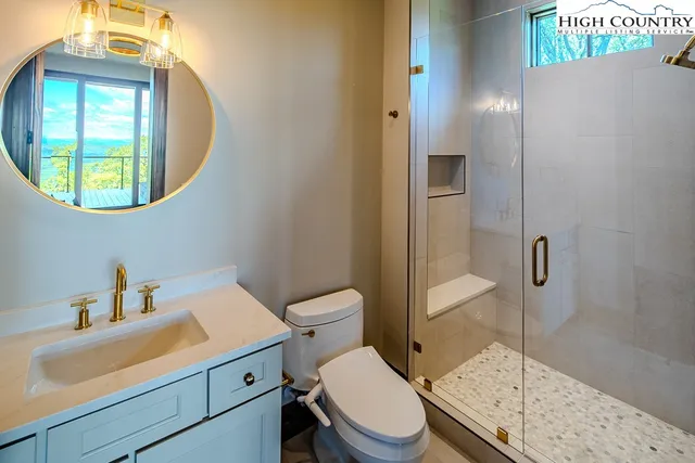 a bathroom with a toilet a sink and mirror