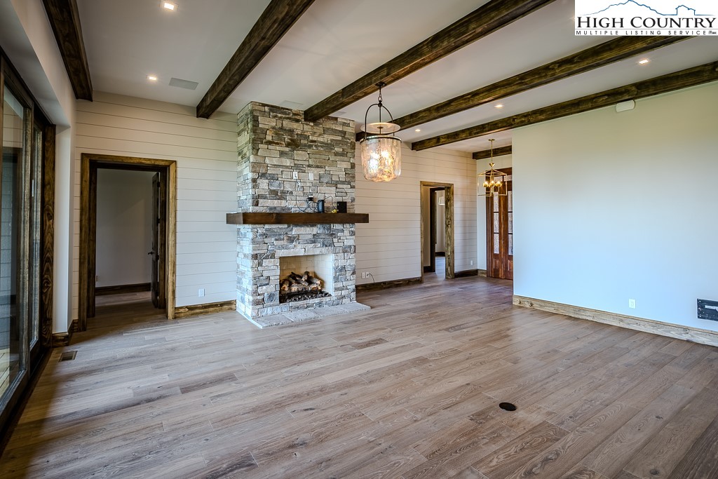 2005 Moon Run Linville, NC 28646 - Photo 4 of 37 an empty room with wooden floor and fireplace