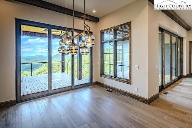 a view of a room with wooden floor and door