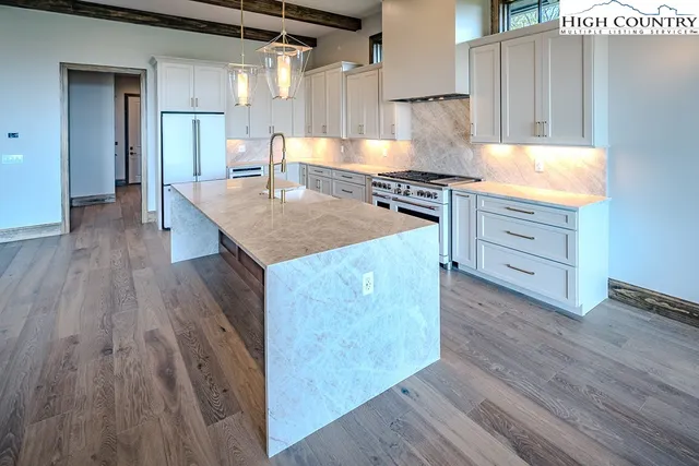 a kitchen with wooden floors and white appliances