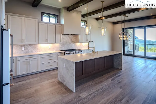 a kitchen with a sink cabinets and wooden floor