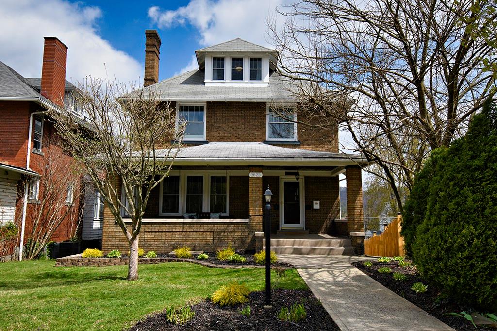 Welcome HOME to 1623 Ridge Ave! Walk up the new concrete sidewalk and onto the resurfaced front porch.  You will be greeted by the beautiful wood front door! Please come in!