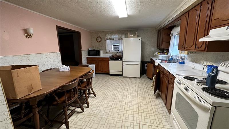 89 State Rte 908 Extension Tarentum, PA 15084 - Photo 29 of 48 a kitchen that has a table chairs and a refrigerator