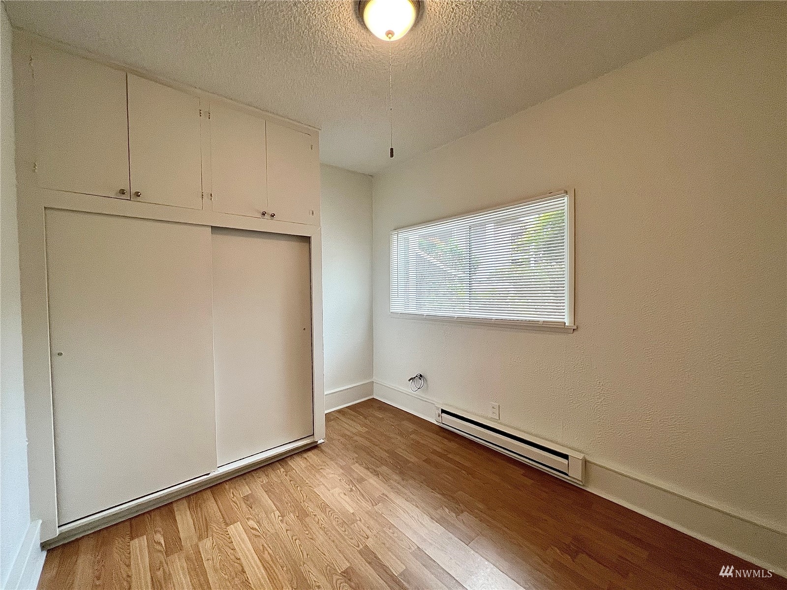 432 Cedar Avenue South Renton, WA 98057 - Photo 12 of 38 a view of room with window and wooden floor