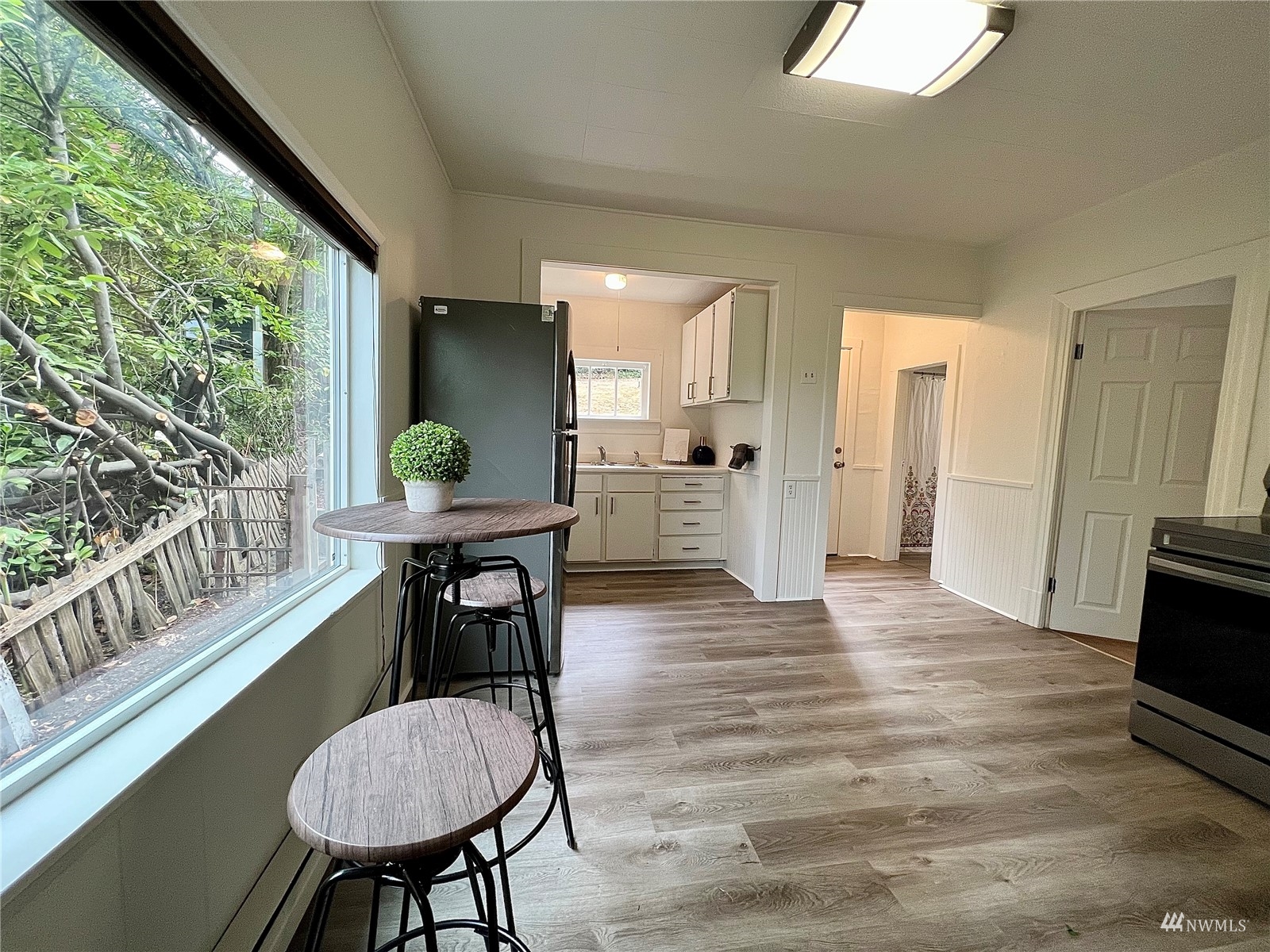 432 Cedar Avenue South Renton, WA 98057 - Photo 13 of 38 a view of a dining room with furniture window and wooden floor
